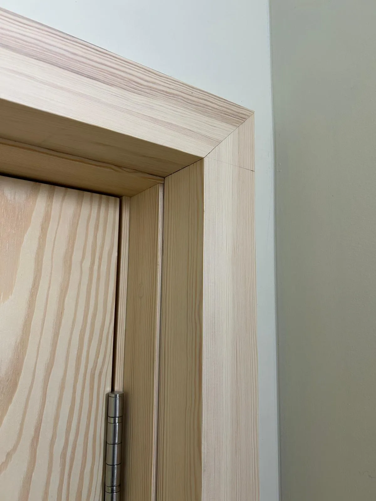 Close-up of an architrave mitre above a door, on the hinge side