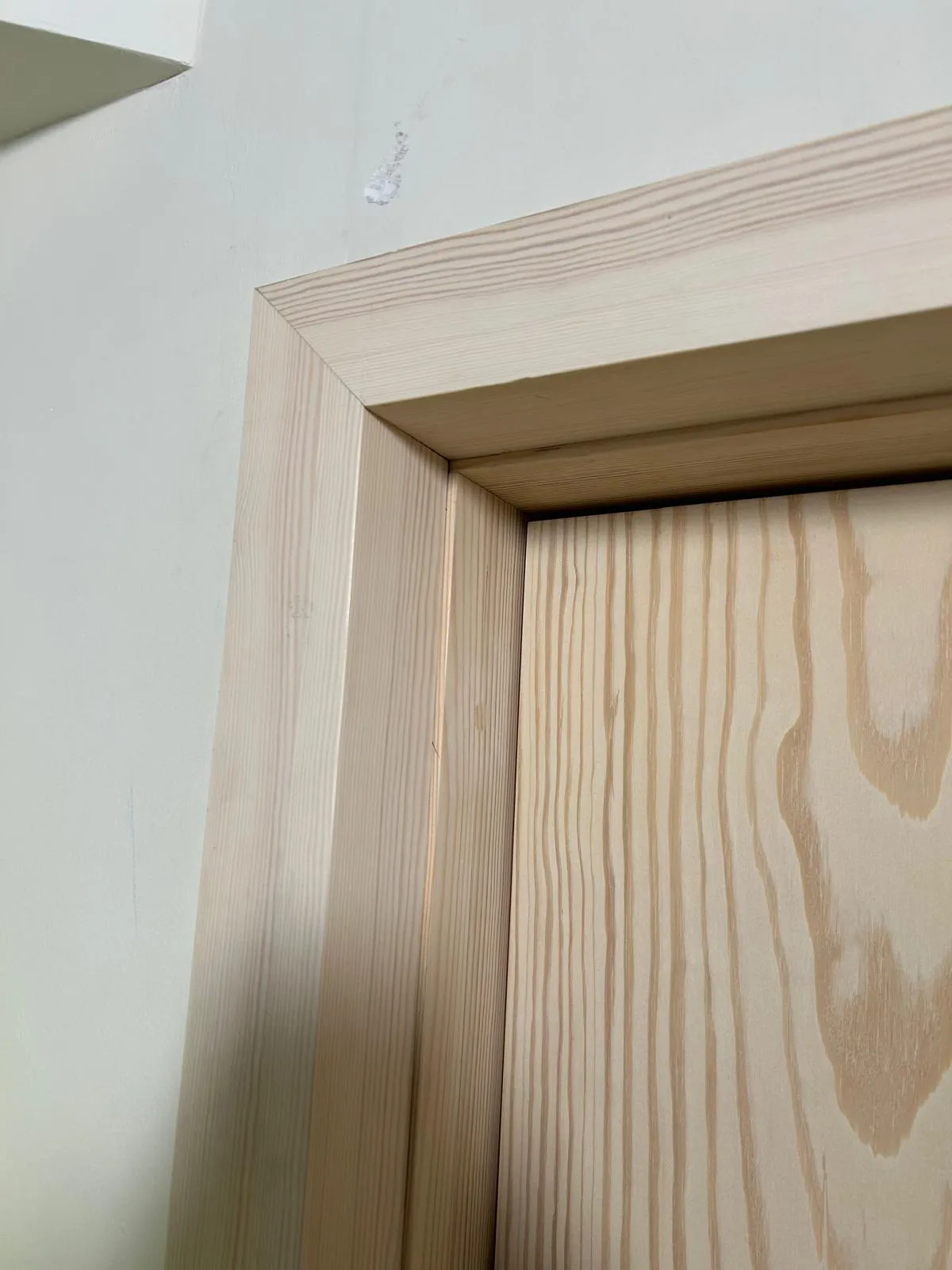 Close-up of a door lining mitred at the head