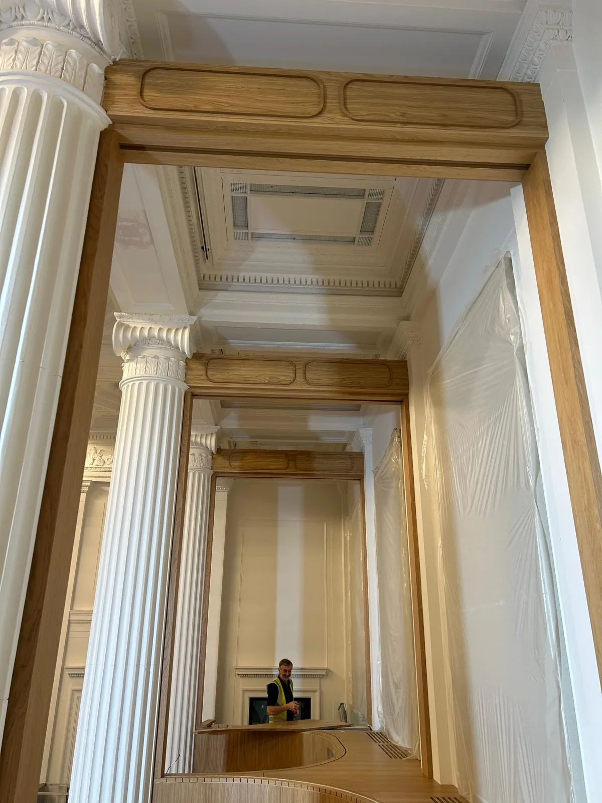 An oak-lined opening between two columns